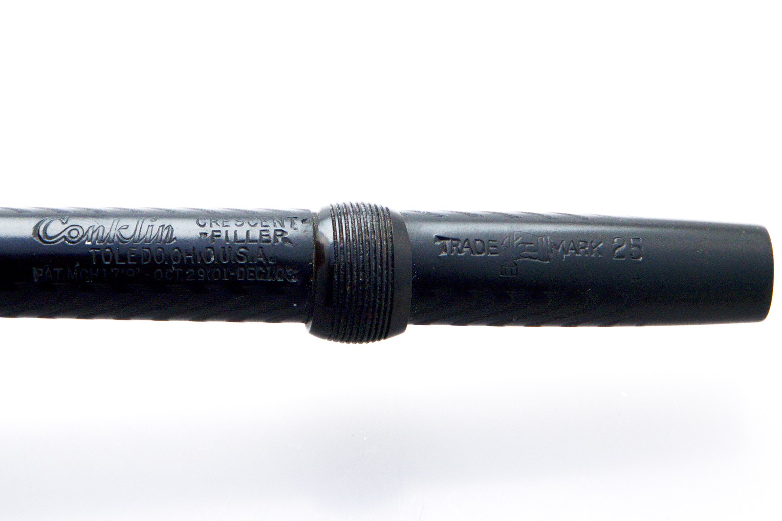 Close-up of the barrel imprint reading Conklin Crescent-Filler, Toledo, Ohio, U.S.A., with three patent dates, and the Conklin trade mark with the number 25 beyond the locking ring
