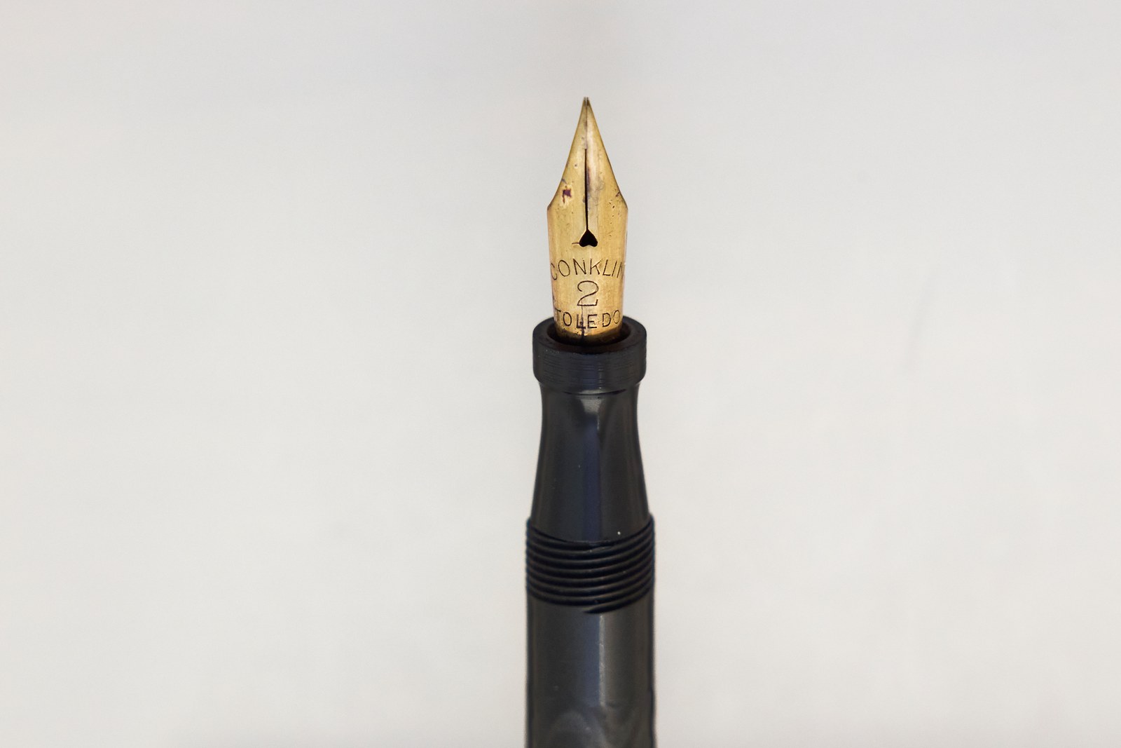 Gold-coloured nib stamped Conklin 2 Toledo, with a heart-shaped breather hole, in a black hard rubber section