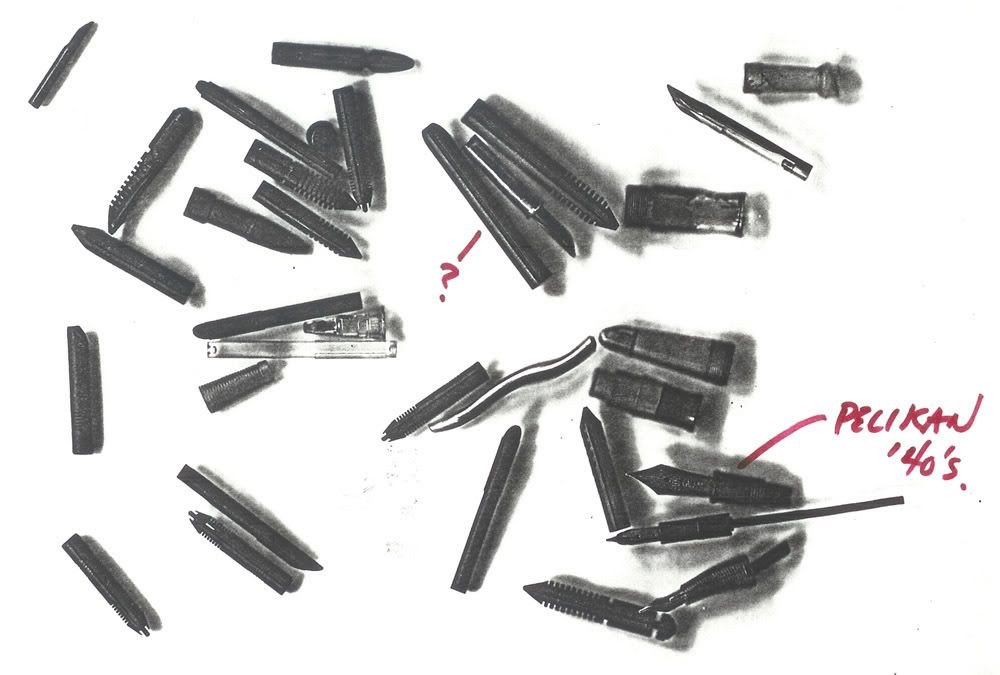 Loose nibs, feeds and sections, one marked as a 1940s Pelikan, annotated by hand.